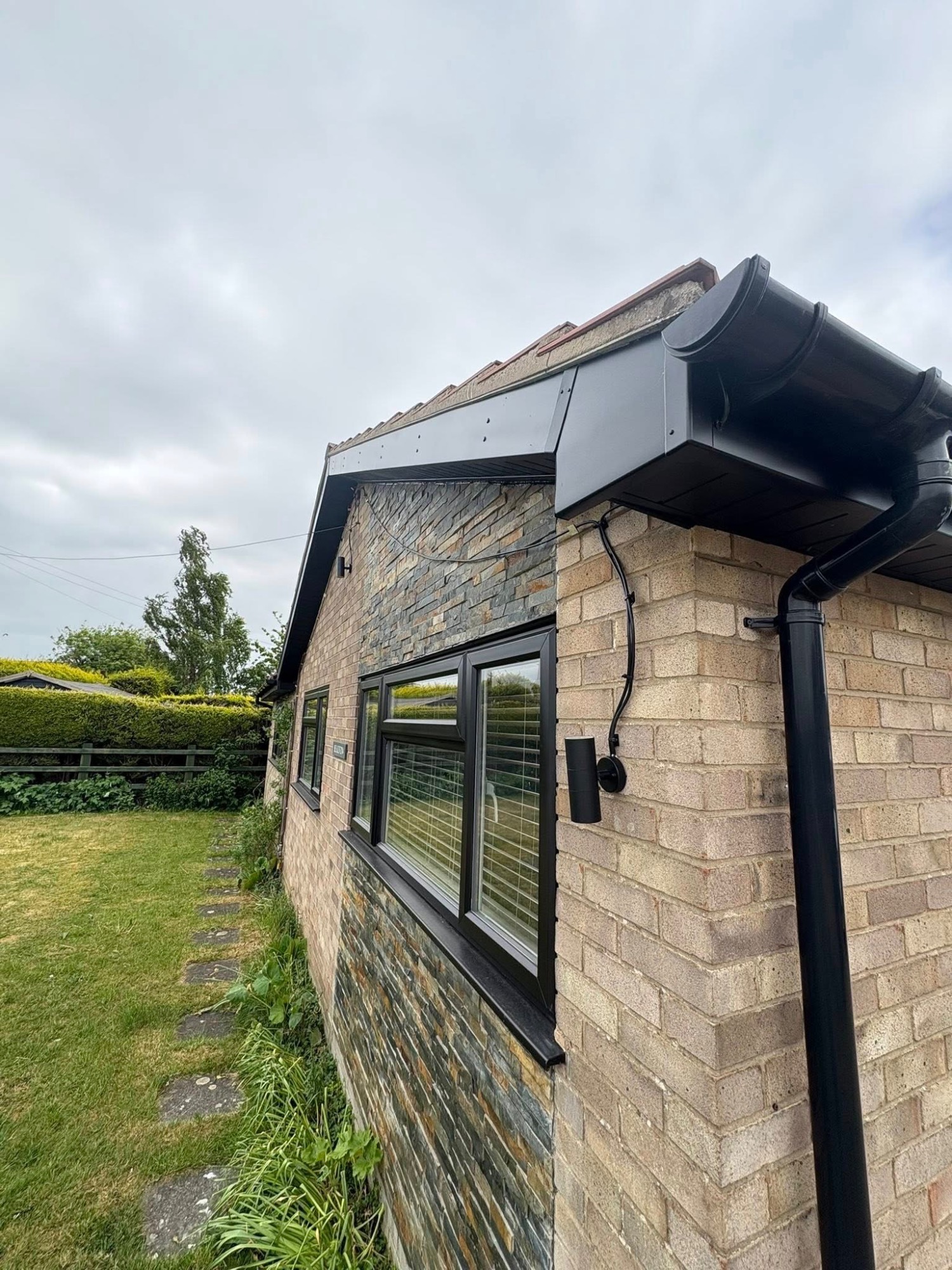 Black UPVC windows and gutters paint spraying