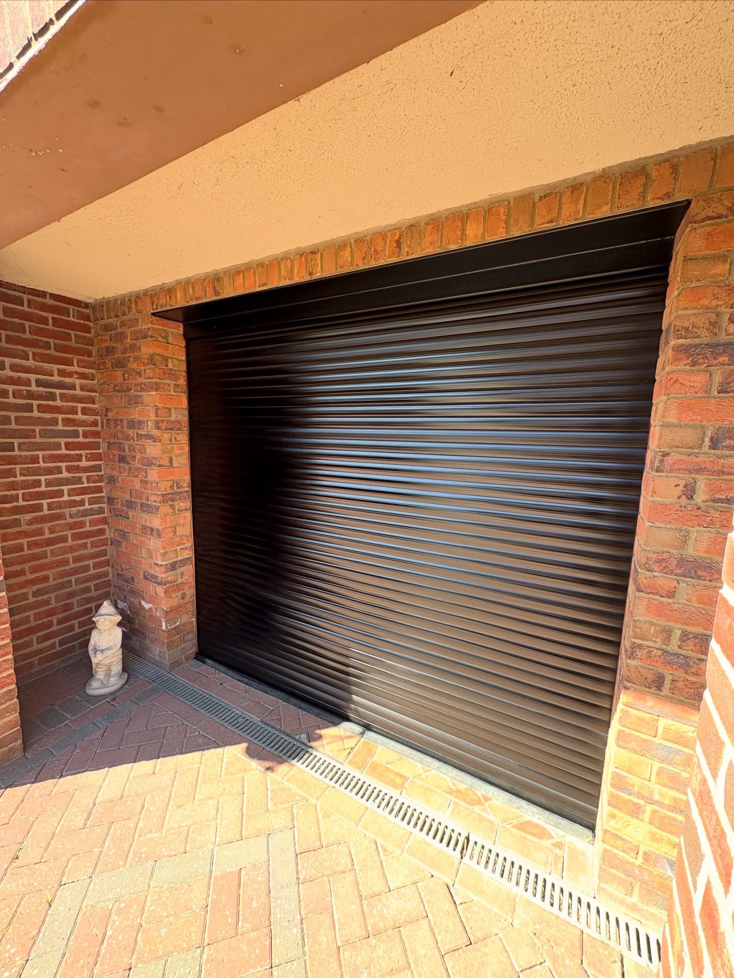 Black garage door refurbishment with spray painting